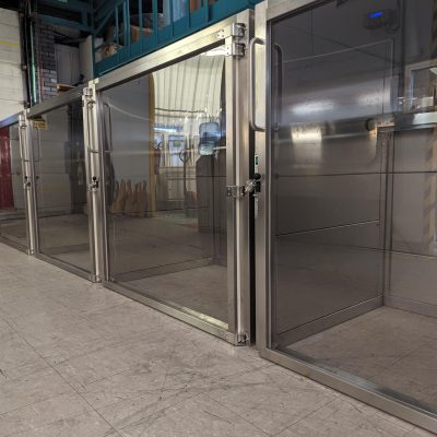 Garment Transfer Chamber with Letter Box Hinged Doors to One Side and Interlocked Hinged Doors to the Opposite Side
