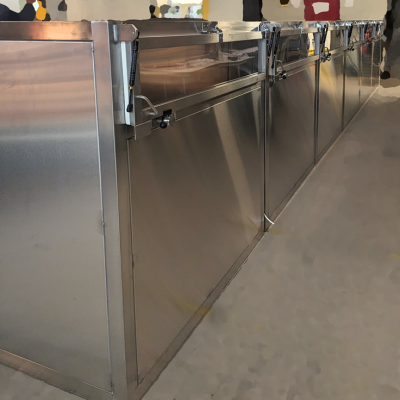 Garment Transfer Chamber with Letter Box Hinged Doors to One Side and Interlocked Hinged Doors to the Opposite Side